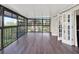 Bright sunroom features beautiful hardwood flooring, large windows, and access to the outdoors at 4312 Sunray Ct # 36, Tampa, FL 33615