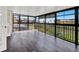 Empty sunroom with walls of windows offering abundant natural light and outdoor views at 4312 Sunray Ct # 36, Tampa, FL 33615