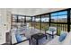 Bright sunroom features floor-to-ceiling windows, comfortable seating, and dining set at 4312 Sunray Ct # 36, Tampa, FL 33615