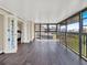 Large sunroom with wood look flooring, access to bedroom, and lots of natural light at 4312 Sunray Ct # 36, Tampa, FL 33615