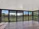 Spacious sunroom with black framed windows and tranquil views of the surrounding landscape at 4312 Sunray Ct # 36, Tampa, FL 33615