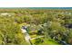 A generous home site is captured from above surrounded by mature trees and verdant lawns, with a long driveway at 4411 Culbreath Rd, Valrico, FL 33596