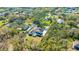 Aerial view of a house with a pool and large fenced-in yard amid lush greenery at 4411 Culbreath Rd, Valrico, FL 33596