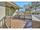 Lovely wood back porch with ceiling fan, outdoor seating, and wood railing for outdoor relaxation at 4411 Culbreath Rd, Valrico, FL 33596