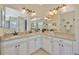 Bathroom features dual sinks, granite counters, and decorative mirrors and lighting at 4411 Culbreath Rd, Valrico, FL 33596