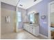 Well-lit bathroom featuring granite counters, a linen closet and a shower with curtain at 4411 Culbreath Rd, Valrico, FL 33596