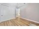Neutral bedroom with light wood floors and convenient double closet doors at 4411 Culbreath Rd, Valrico, FL 33596