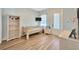 A cozy bedroom featuring wood-look flooring, bunkbeds, and a smart TV at 4411 Culbreath Rd, Valrico, FL 33596