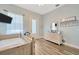 Bedroom featuring an ensuite door to exterior and light blue walls at 4411 Culbreath Rd, Valrico, FL 33596