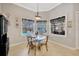 Bright breakfast nook with a glass table and views of the screened lanai and pool at 4411 Culbreath Rd, Valrico, FL 33596