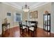 Elegant dining room with wood floors, a modern chandelier, and stylish decor at 4411 Culbreath Rd, Valrico, FL 33596