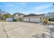 Spacious driveway leading to a home with a three-car garage and an additional outbuilding providing ample parking at 4411 Culbreath Rd, Valrico, FL 33596