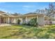 Charming home featuring a covered porch, lush lawn, and well-manicured landscaping at 4411 Culbreath Rd, Valrico, FL 33596