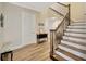 Grand foyer with hardwood flooring and a staircase with decorative wrought iron spindles at 4411 Culbreath Rd, Valrico, FL 33596