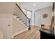 Inviting foyer featuring wood floors, decorative molding, and staircase with iron spindles at 4411 Culbreath Rd, Valrico, FL 33596