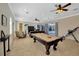 Entertaining game room featuring billiards table with outdoor views and adjacent seating at 4411 Culbreath Rd, Valrico, FL 33596