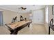 Relaxing game room featuring billiards table with workout equipment and natural lighting at 4411 Culbreath Rd, Valrico, FL 33596