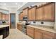 Gourmet kitchen features granite countertops, brown cabinets, and stainless steel appliances at 4411 Culbreath Rd, Valrico, FL 33596