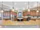 Gourmet kitchen with granite countertops, stainless steel appliances, and brown wood cabinetry at 4411 Culbreath Rd, Valrico, FL 33596