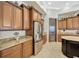Gourmet kitchen features wood cabinets, granite countertops, and stainless steel appliances at 4411 Culbreath Rd, Valrico, FL 33596