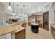 Open kitchen with granite countertops, stainless steel appliances, and a center island at 4411 Culbreath Rd, Valrico, FL 33596