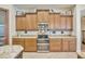This kitchen boasts beautiful brown cabinets, granite countertops, and stainless steel appliances at 4411 Culbreath Rd, Valrico, FL 33596