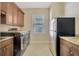 Bright laundry room boasts modern washer/dryer, built-in cabinets and granite countertops at 4411 Culbreath Rd, Valrico, FL 33596