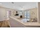 Bright living room with a ceiling fan, TV, and access to the backyard through glass doors at 4411 Culbreath Rd, Valrico, FL 33596