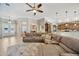 Spacious living room featuring a large sectional sofa, open layout, and access to the kitchen at 4411 Culbreath Rd, Valrico, FL 33596