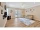 Open-concept living room with natural light, fan, and double doors leading to the lanai at 4411 Culbreath Rd, Valrico, FL 33596