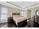 Spacious main bedroom features trey ceiling, dark wood floors, and ample natural light at 4411 Culbreath Rd, Valrico, FL 33596