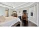 Bright main bedroom with trey ceilings, dark wood floors and neutral paint at 4411 Culbreath Rd, Valrico, FL 33596