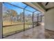 Spacious screened-in patio with tile flooring, offering views of the lush backyard at 4411 Culbreath Rd, Valrico, FL 33596