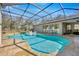 Sparkling in-ground pool with a sundeck and screened enclosure, perfect for relaxation at 4411 Culbreath Rd, Valrico, FL 33596