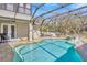Enjoy the refreshing screened-in pool and spa, set against a backdrop of lush greenery, for ultimate relaxation at 4411 Culbreath Rd, Valrico, FL 33596