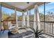 Relaxing sunroom featuring a unique papasan chair, throw pillows, and sheer curtains at 4411 Culbreath Rd, Valrico, FL 33596