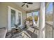 Screened balcony with outdoor furniture, sheer white curtains, and peaceful, wooded views at 4411 Culbreath Rd, Valrico, FL 33596
