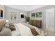 Well-lit bedroom features neutral decor, two windows, stylish furnishings, and ensuite bathroom at 4500 22Nd S Ave, St Petersburg, FL 33711