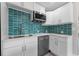 Updated kitchen with a stylish backsplash, stainless steel appliances, and white cabinetry at 4500 22Nd S Ave, St Petersburg, FL 33711