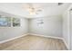 Empty bedroom with wood laminate flooring, bright natural light, and neutral walls at 4912 Bay Park Dr, Port Richey, FL 34668