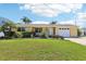 Charming single-story home with a lush green lawn and neatly manicured landscaping at 4912 Bay Park Dr, Port Richey, FL 34668