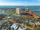 Aerial view displays waterfront home with dock, canal access, and proximity to a high-rise building at 4959 58Th S Ave, St Petersburg, FL 33715