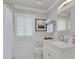 Clean, updated bathroom featuring a white vanity, mirror with light fixture, toilet, and shower with curtain at 4959 58Th S Ave, St Petersburg, FL 33715