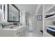 Bright bathroom featuring granite countertops, modern fixtures, and an exterior view of the pool area at 4959 58Th S Ave, St Petersburg, FL 33715