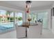 Charming dining area with views of pool and canal through large sliding glass doors at 4959 58Th S Ave, St Petersburg, FL 33715