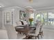 Elegant dining room with modern light fixture and shuttered windows, perfect for entertaining guests at 4959 58Th S Ave, St Petersburg, FL 33715