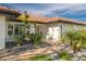 Inviting walkway with brick pavers leading to a front door, complemented by rock gardens with tropical plants at 4959 58Th S Ave, St Petersburg, FL 33715