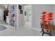 Bright hallway featuring white tile flooring, decorative doors, and a glimpse into the bathroom at 4959 58Th S Ave, St Petersburg, FL 33715