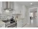 Bright kitchen with modern appliances, marble backsplash, and range hood at 4959 58Th S Ave, St Petersburg, FL 33715