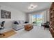 Bright living room with a couch and sliding door view of the water, with white carpet and modern lighting at 4959 58Th S Ave, St Petersburg, FL 33715